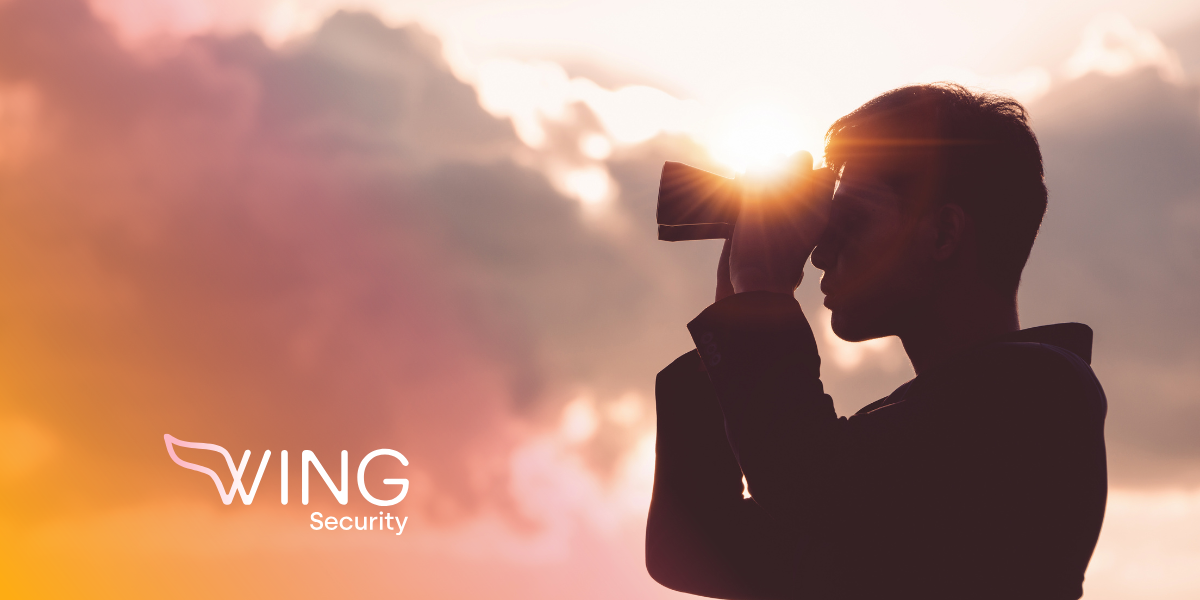 man looking through binoculars Wing Security